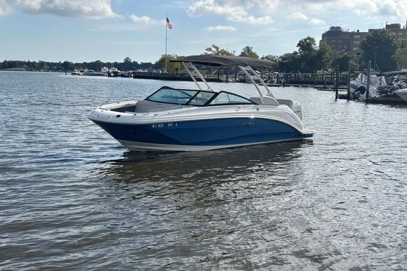 Slide: The Image of 2025 Sea Ray SDX 250 Outboard boat on calm water, with American flag in background. - 3