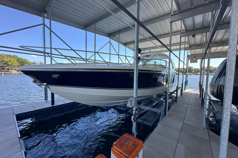 Slide: The Image of 2007 Formula 400 Super Sport boat cruising near waterfront buildings and docks. - 2