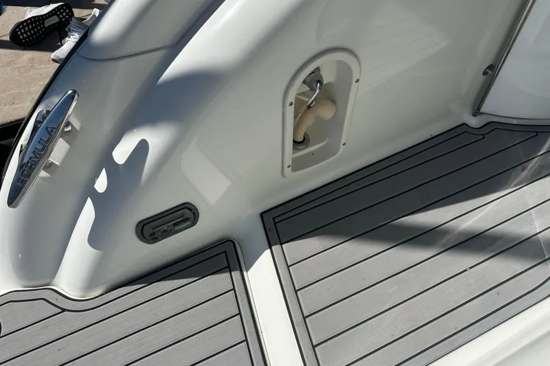 Slide: The Image of 2007 Formula 400 Super Sport boat interior with helm, white seating, and lake view. - 30