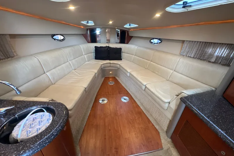 Slide: The Image of 2007 Formula 400 Super Sport boat docked under a covered marina with scenic lake view. - 40