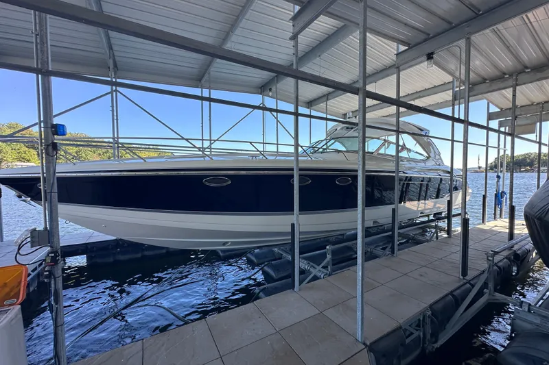 Slide: The Image of 2007 Formula 400 Super Sport boat docked at a marina, surrounded by buildings and trees. - 5