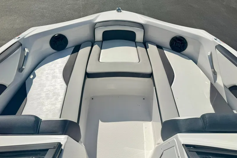 Slide: The Image of 2022 Yamaha Boats SX195 interior with cushioned seating and built-in speakers. - 12