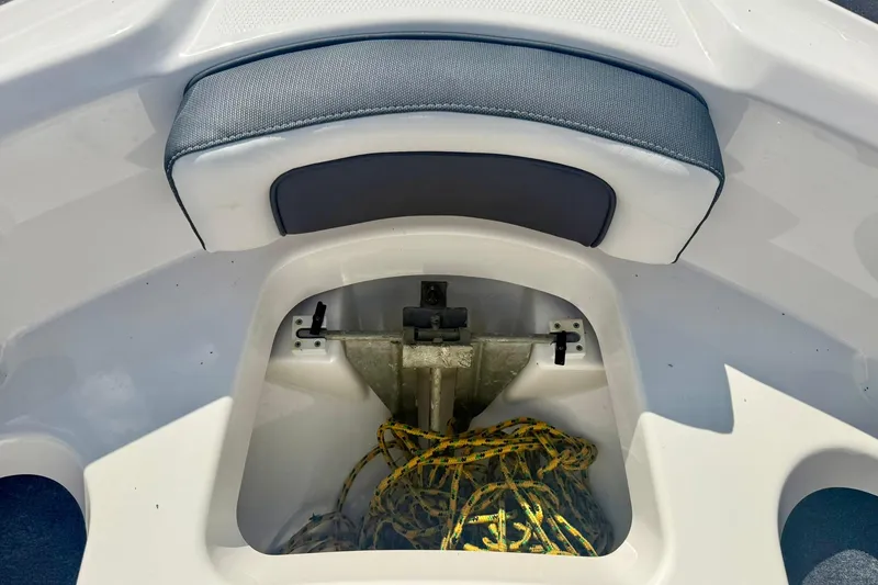 Slide: The Image of 2022 Yamaha Boats SX195 anchor storage with rope and cushioned seating. - 14