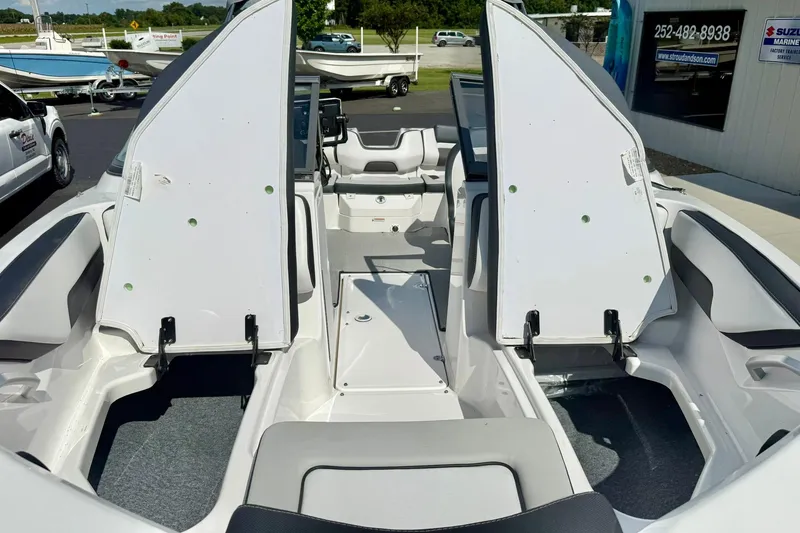 Slide: The Image of 2022 Yamaha Boats SX195 interior with open storage compartments, showcasing sleek design and seating. - 15