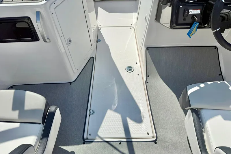Slide: The Image of Interior view of 2022 Yamaha Boats SX195, featuring sleek seating and control panel. - 28