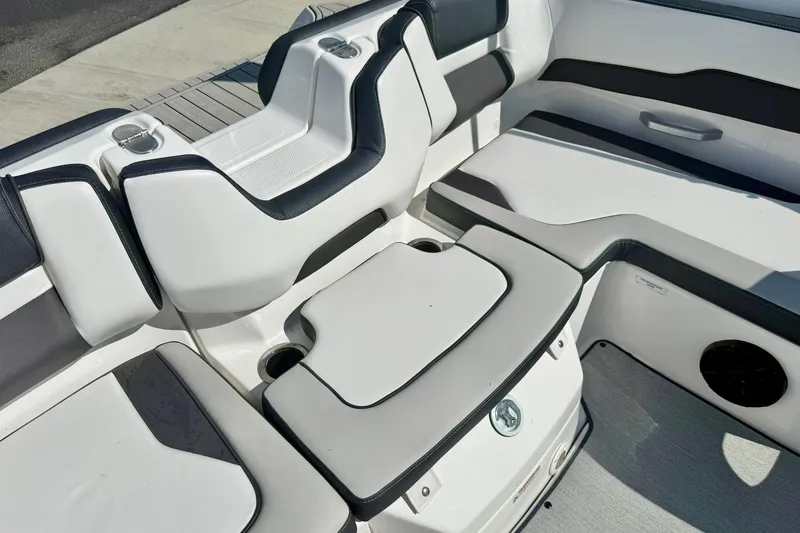 Slide: The Image of 2022 Yamaha Boats SX195 interior seating with cup holders and sleek design. - 31