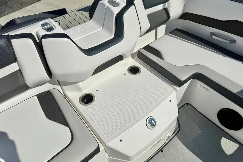 Slide: The Image of 2022 Yamaha Boats SX195 interior seating with cup holders and sleek design. - 32