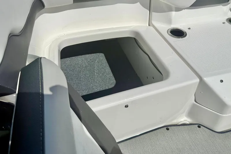 Slide: The Image of 2022 Yamaha Boats SX195 storage compartment with open hatch, showcasing interior space. - 34