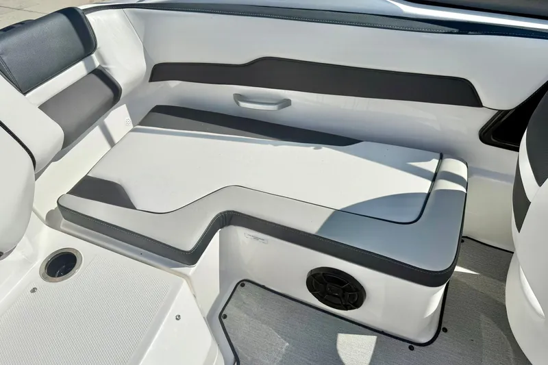 Slide: The Image of 2022 Yamaha Boats SX195 interior seating with sleek design and integrated speaker. - 35