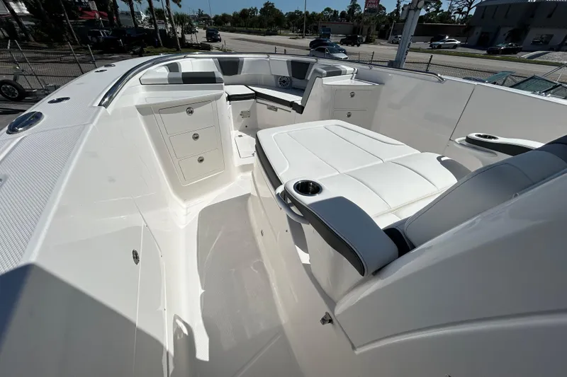 Slide: The Image of 2026 Robalo R360 Center Console boat interior with white seating and storage compartments. - 10