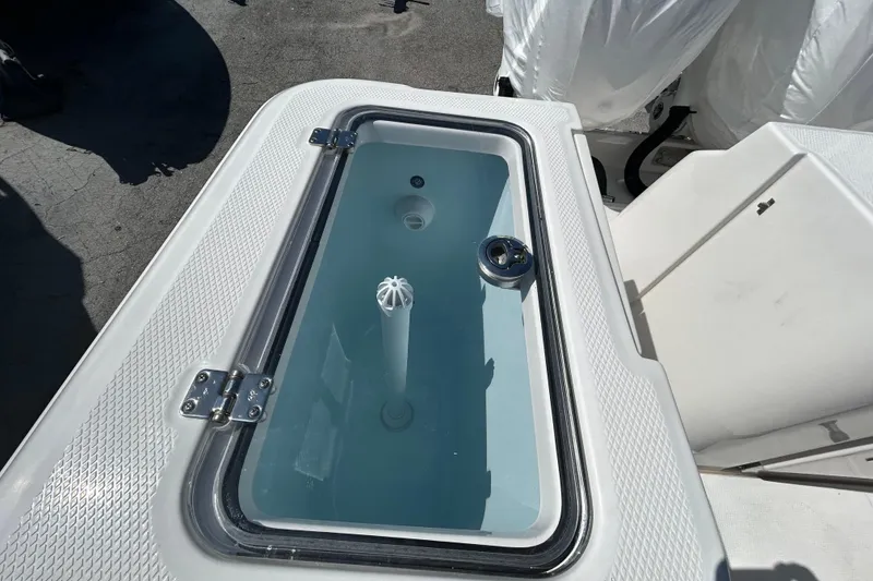 Slide: The Image of Livewell on 2026 Robalo R360 Center Console boat, featuring a clear lid and water circulation system. - 17