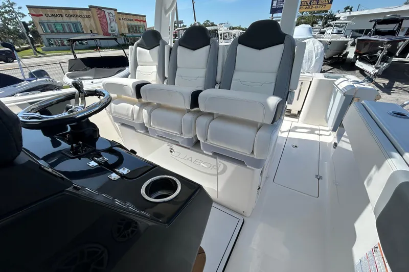 Slide: The Image of 2026 Robalo R360 Center Console boat interior with luxurious seating and steering wheel. - 20