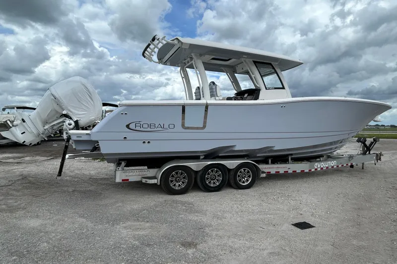 Slide: The Image of 2026 Robalo R360 Center Console boat on a trailer under cloudy skies. - 3