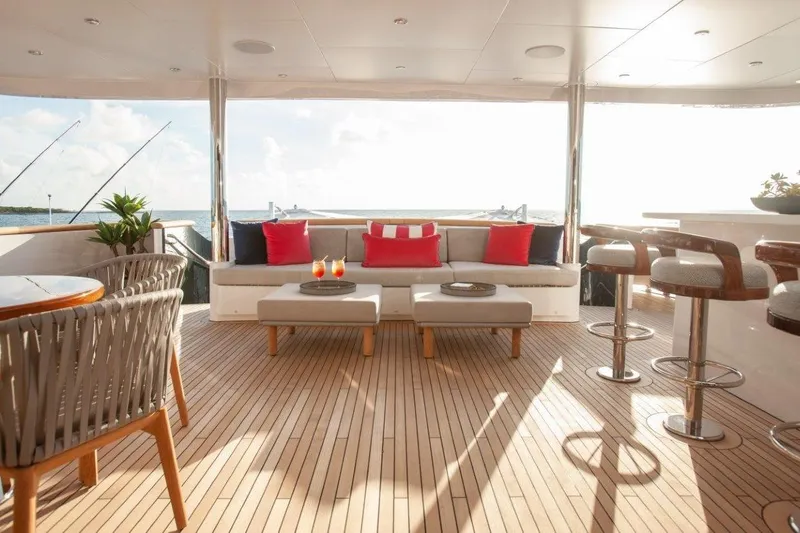 Slide: The Image of Luxurious Trinity Yachts 160 deck with elegant seating, bar stools, and ocean view. - 10