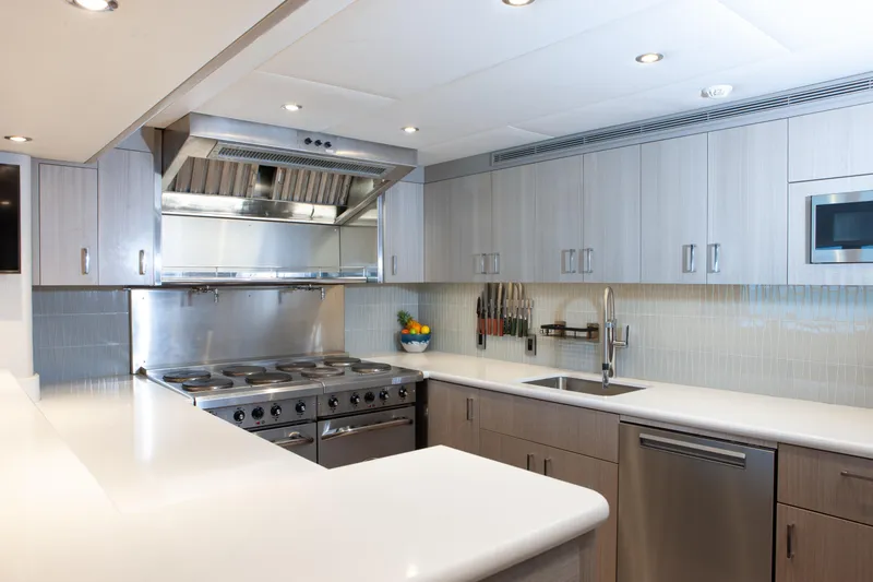 Slide: The Image of Modern kitchen interior on 2000 Trinity Yachts Trinity 160, featuring stainless steel appliances. - 24