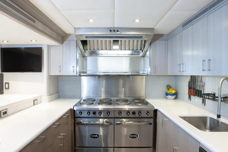 Slide: The Image of Modern kitchen in 2000 Trinity Yachts Trinity 160, featuring stainless steel appliances and sleek cabinetry. - 25