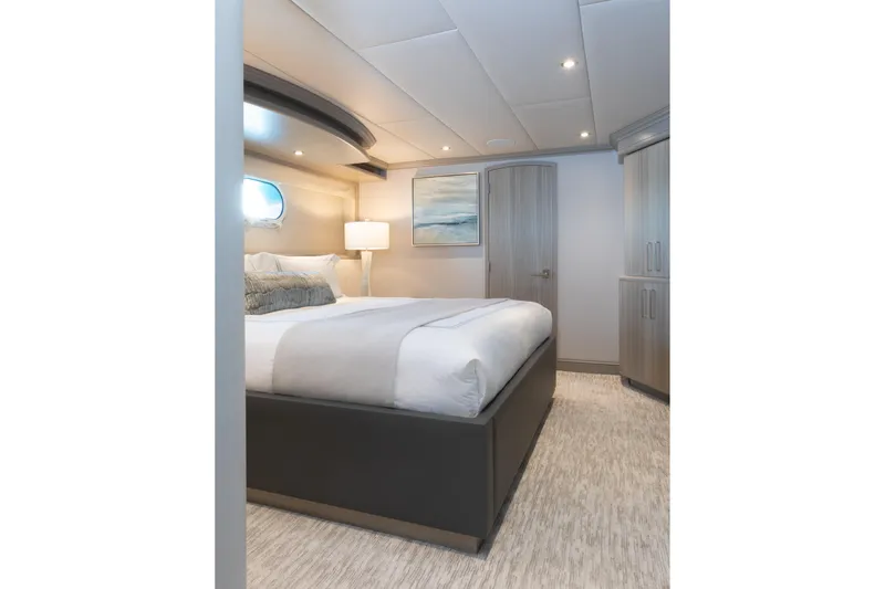 Slide: The Image of Luxurious bedroom interior on 2000 Trinity Yachts Trinity 160, featuring modern decor and ambient lighting. - 31