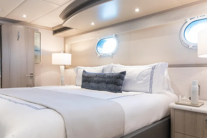Slide: The Image of Luxurious bedroom interior on 2000 Trinity Yachts Trinity 160, featuring elegant bedding and porthole windows. - 34