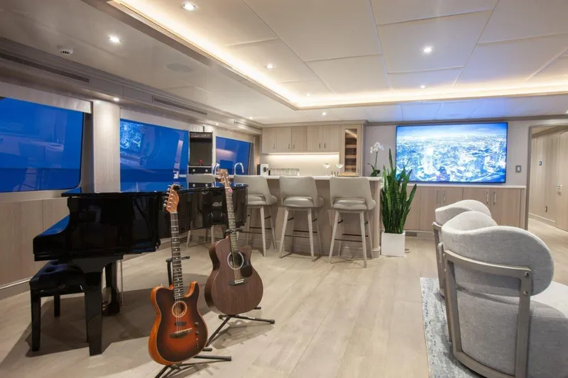 Slide: The Image of Luxurious interior of 2000 Trinity Yachts Trinity 160 with piano, guitars, and modern bar area. - 35