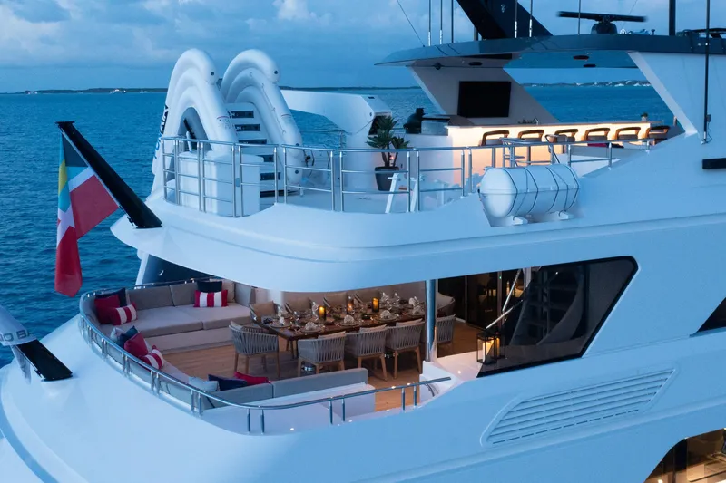 Slide: The Image of Luxurious Trinity Yachts 160, 2000 model, featuring elegant outdoor seating and dining area at sea. - 39