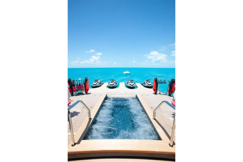 Slide: The Image of Luxurious Trinity Yachts 160, 2000 model, with pool and jet skis on turquoise ocean. - 4