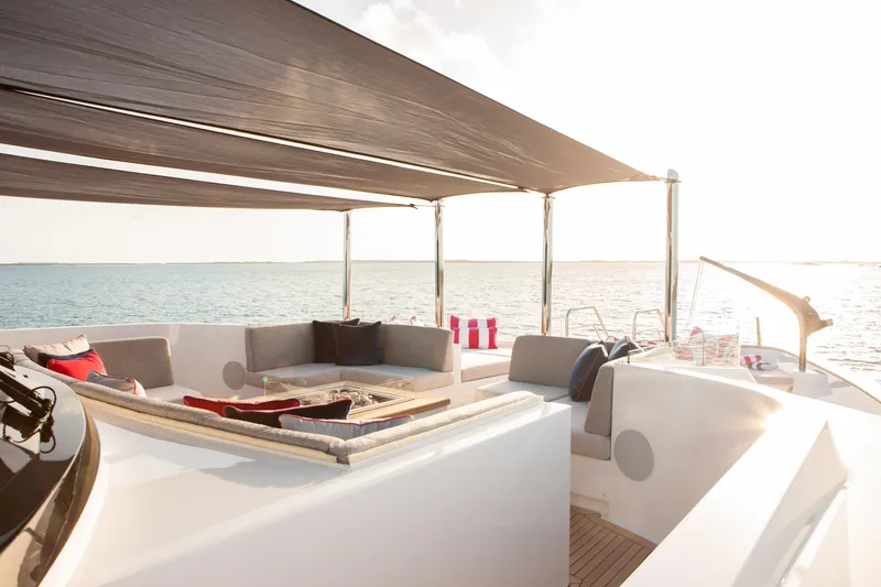 Slide: The Image of Luxurious Trinity Yachts Trinity 160 deck with elegant seating, ocean view, and sunshade. - 40
