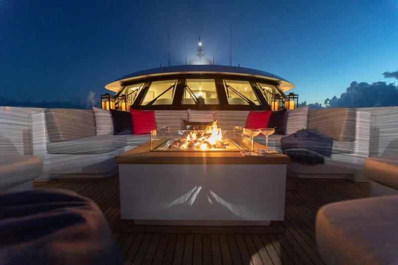 Slide: The Image of Luxurious Trinity 160 yacht deck with fire pit and seating at sunset, 2000 model. - 43