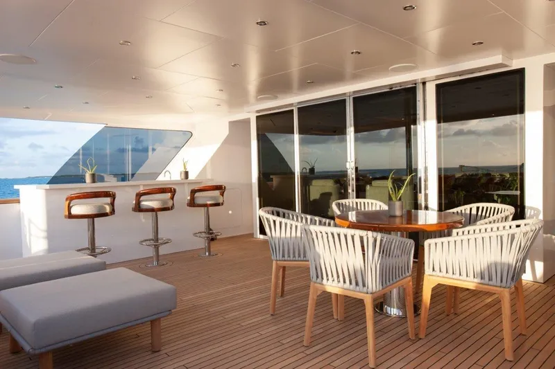 Slide: The Image of Luxurious deck of 2000 Trinity Yachts Trinity 160 with bar and seating area. - 8
