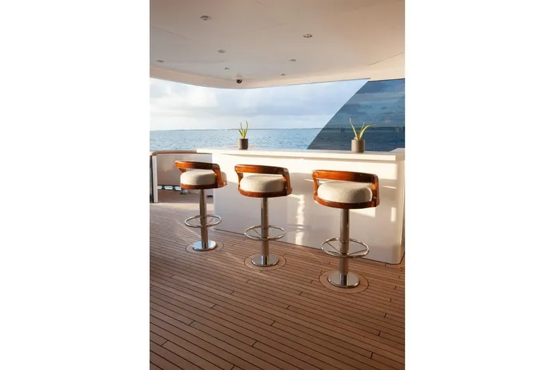 Slide: The Image of Luxurious Trinity Yachts 160 deck with bar stools and ocean view, 2000 model. - 9