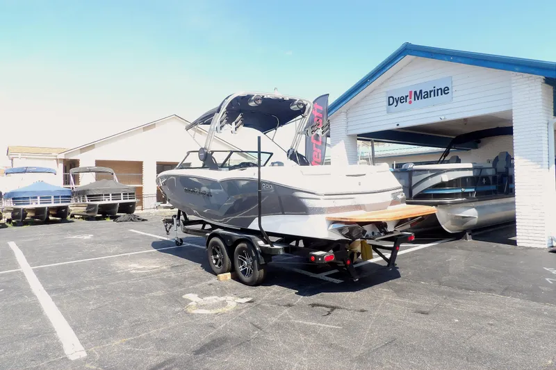 Slide: The Image of 2023 MasterCraft NXT22 boat on trailer at Dyer Marine dealership. - 2