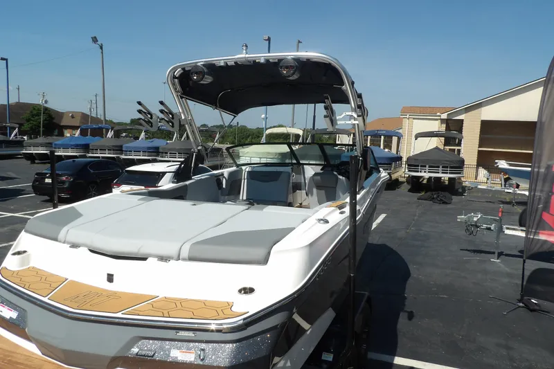 Slide: The Image of 2023 MasterCraft NXT22 boat displayed in a parking lot under clear skies. - 4