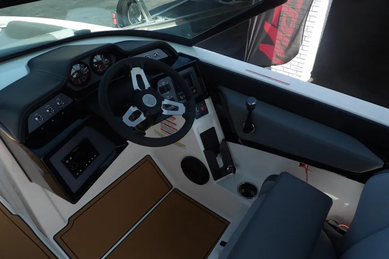 Slide: The Image of 2023 MasterCraft NXT22 boat dashboard with steering wheel and control panel. - 6