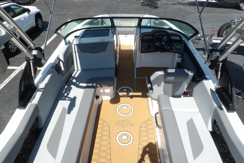 Slide: The Image of 2023 MasterCraft NXT22 boat interior with sleek seating and modern dashboard design. - 7