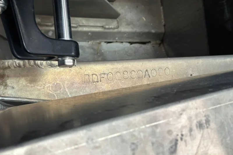 Slide: The Image of 2020 Barletta L25UE pontoon boat on trailer in indoor showroom. - 1