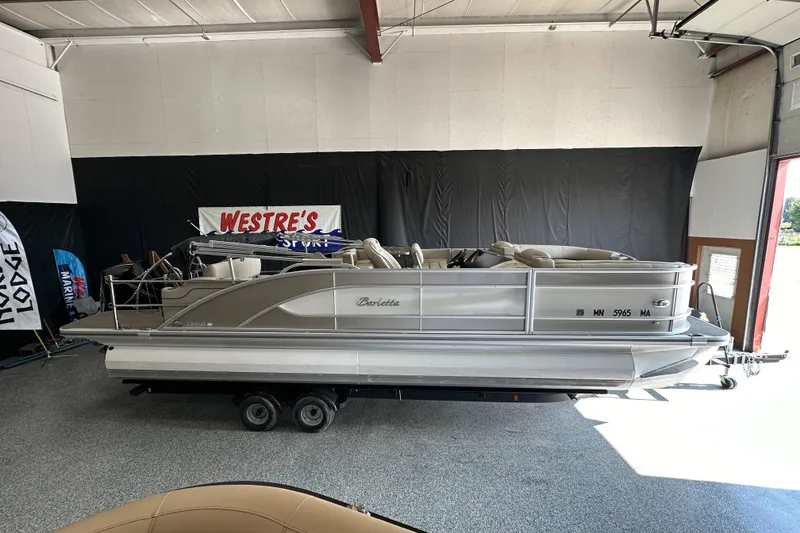 Slide: The Image of 2020 Barletta L25UE pontoon boat interior with luxurious seating and cup holders. - 12