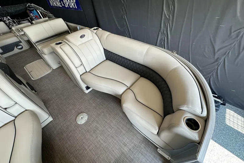 Slide: The Image of 2020 Barletta L25UE pontoon boat interior with beige seating and table. - 15