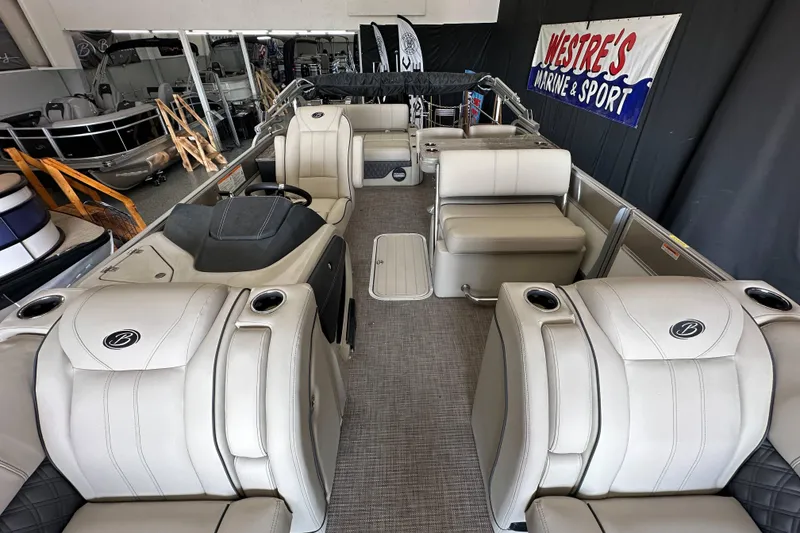 Slide: The Image of 2020 Barletta L25UE pontoon boat interior with luxurious seating in showroom. - 16
