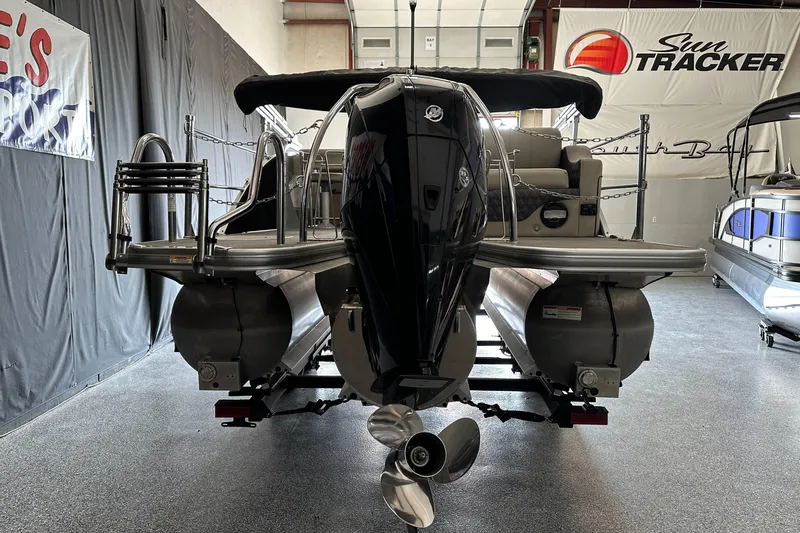 Slide: The Image of 2020 Barletta L25UE pontoon boat in a showroom, side view. - 2