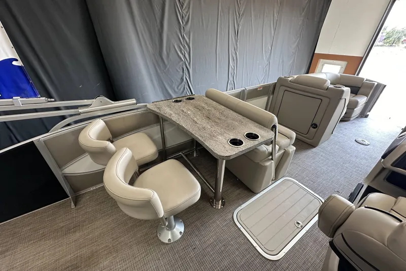 Slide: The Image of 2020 Barletta L25UE pontoon boat interior with plush seating and cup holders. - 21