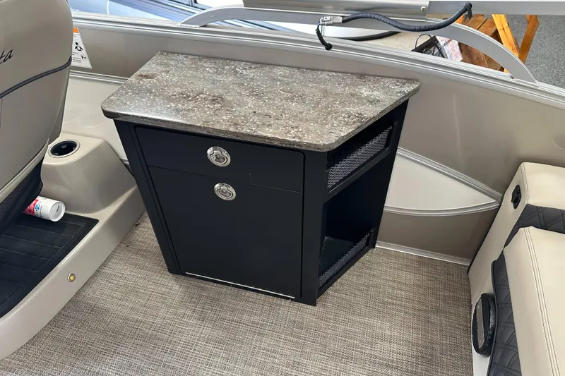 Slide: The Image of 2020 Barletta L25UE pontoon boat with motor, displayed indoors on a showroom floor. - 22