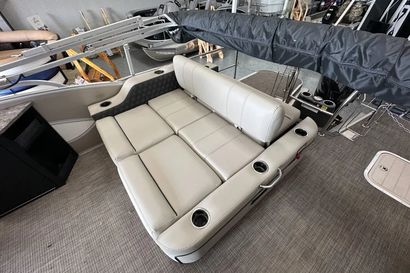 Slide: The Image of 2020 Barletta L25UE pontoon boat interior with beige seating and cup holders. - 23