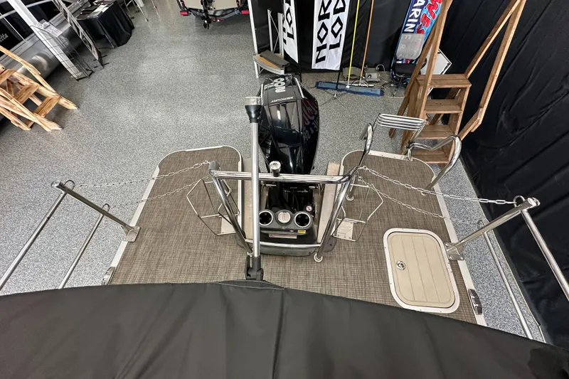 Slide: The Image of 2020 Barletta L25UE pontoon boat interior with beige seating and table. - 24