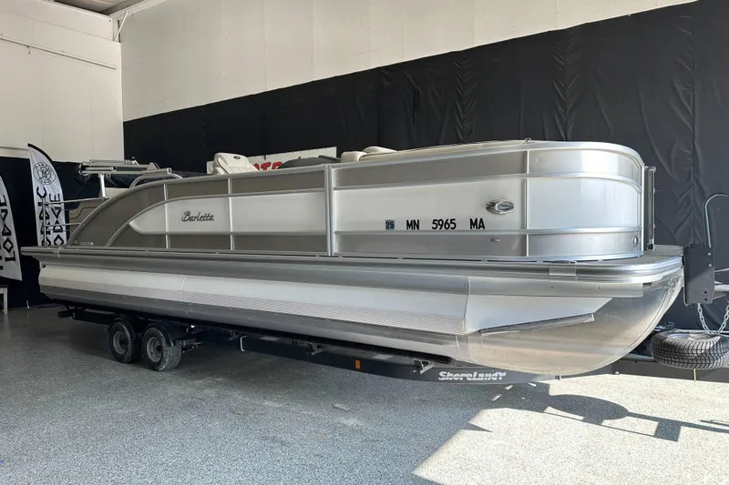 Slide: The Image of 2020 Barletta L25UE pontoon boat in a showroom, featuring sleek design and comfortable seating. - 4