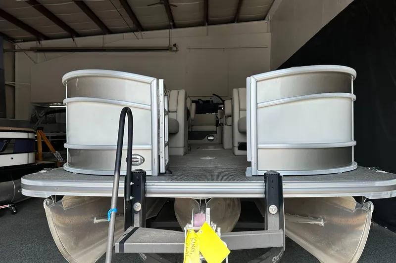 Slide: The Image of 2020 Barletta L25UE pontoon boat in a storage facility, front view. - 5