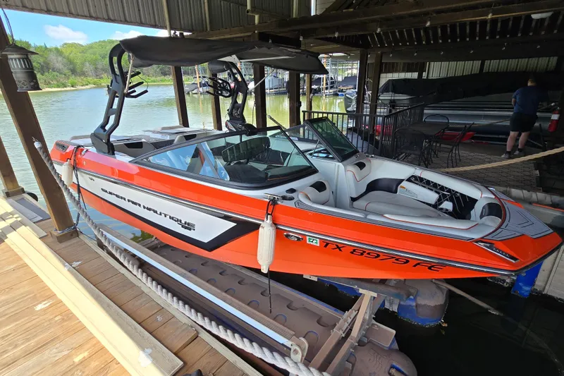 The Image of Orange 2018 Natique GS20 boat docked in a covered marina, ready for water activities. - 0