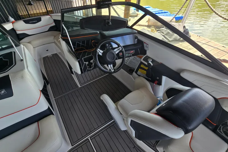 Slide: The Image of Interior of a 2018 Nautique GS20 boat with sleek seating and modern design. - 13