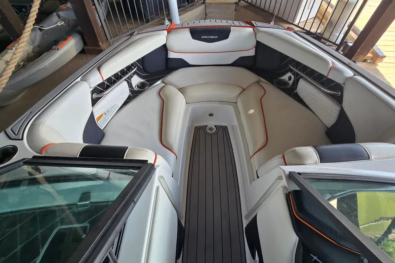 Slide: The Image of Interior of a 2018 Natique GS20 boat with sleek seating and open windshield. - 14