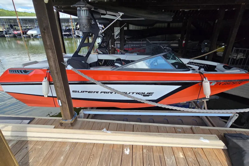 Slide: The Image of Orange and white 2018 Natique GS20 boat docked in a marina. - 3