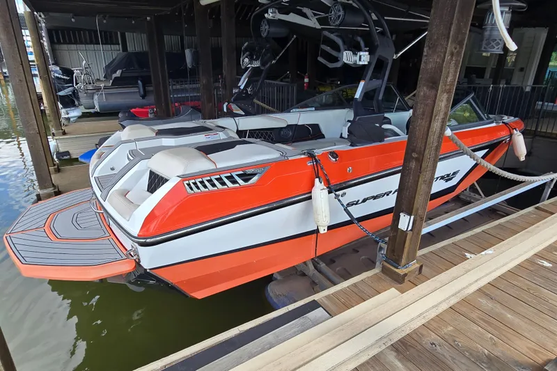 Slide: The Image of Orange and white 2018 Natique GS20 boat docked on a serene lake. - 4