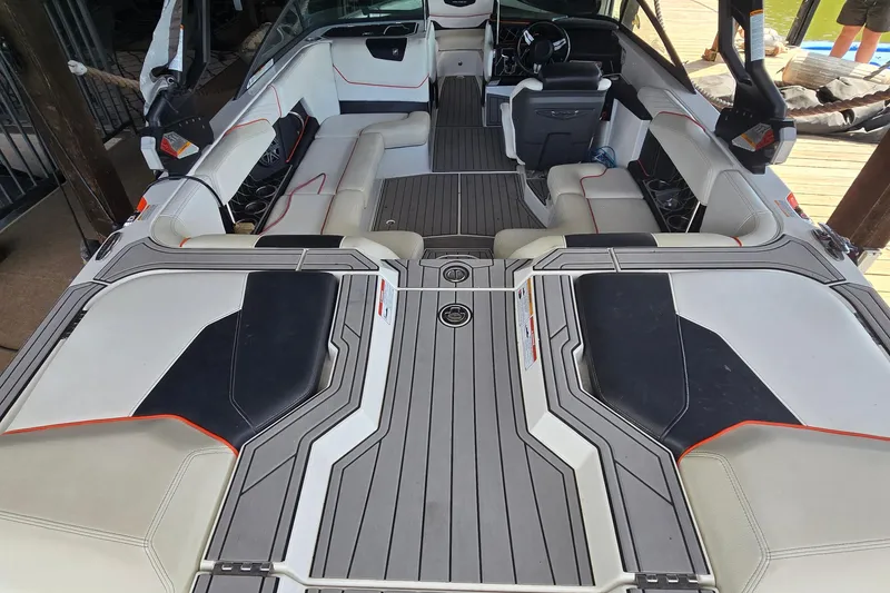 Slide: The Image of 2018 Natique GS20 boat interior with cushioned seating and sleek design by the water. - 8